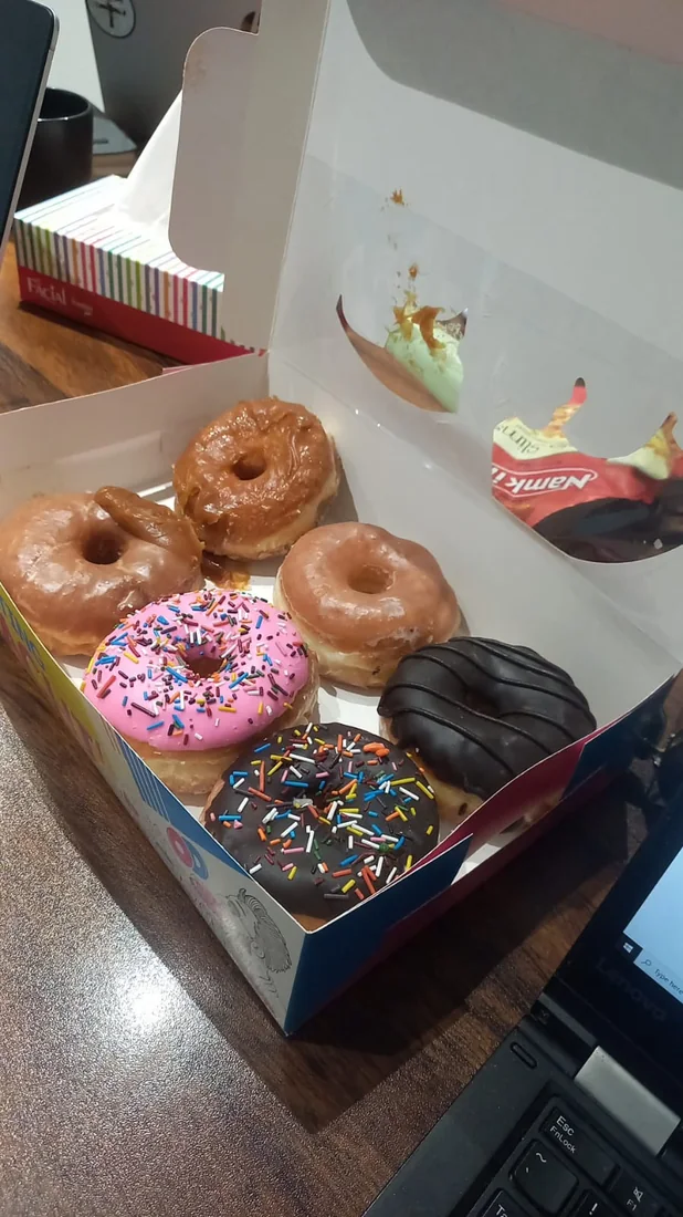 Behind the scenes: a box of donuts on a desk